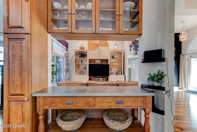 3102 N Springwater Ct N, Port Orange, FL 32128 - kitchen with glass insert cabinets, brown cabinetry, and open shelves