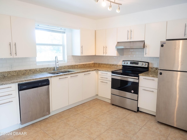 kitchen with light stone countertops, white cabinetry, sink, and stainless steel appliances