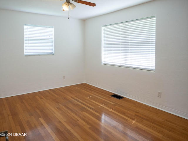 empty room featuring ceiling fan and hardwood / wood-style floors