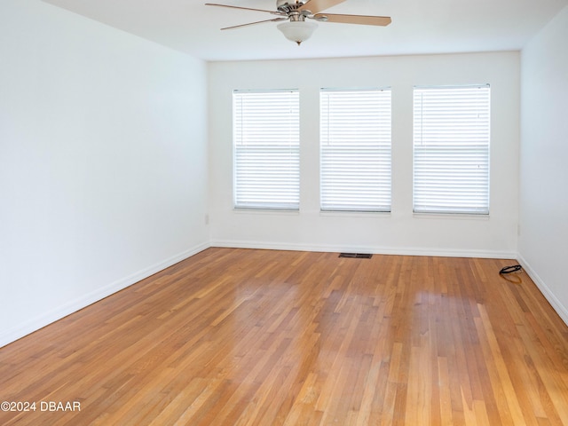 empty room featuring ceiling fan and light hardwood / wood-style flooring