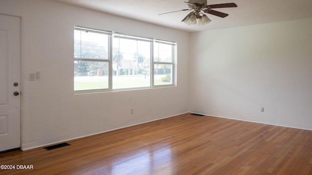 empty room with light wood-type flooring and ceiling fan