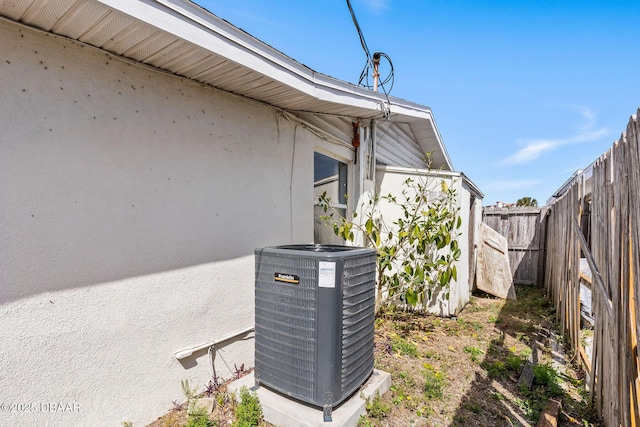 exterior details featuring cooling unit and a fenced backyard