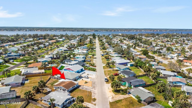 birds eye view of property featuring a water view and a residential view