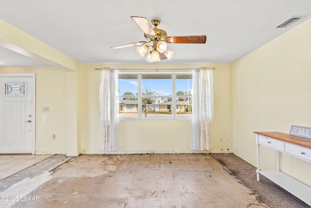 interior space featuring ceiling fan and visible vents