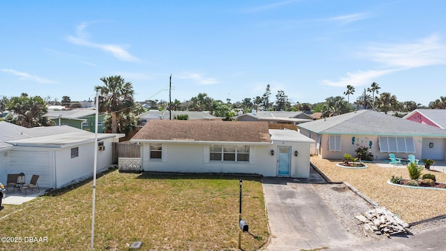 single story home featuring concrete driveway, a patio, a front lawn, and fence