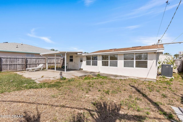 back of house featuring cooling unit, a patio area, fence, and stucco siding