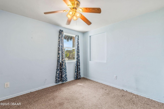 empty room featuring carpet, baseboards, and a ceiling fan