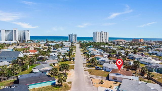 birds eye view of property with a water view and a city view