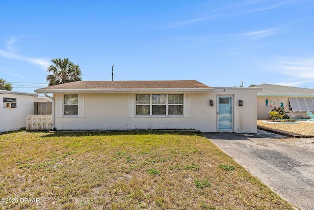 single story home featuring a front yard and stucco siding