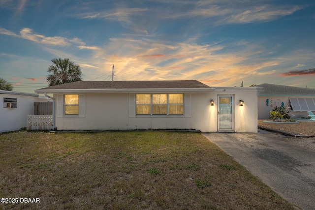 view of front of property featuring a front yard and stucco siding