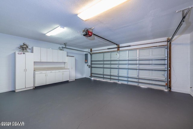 garage with electric panel and a garage door opener