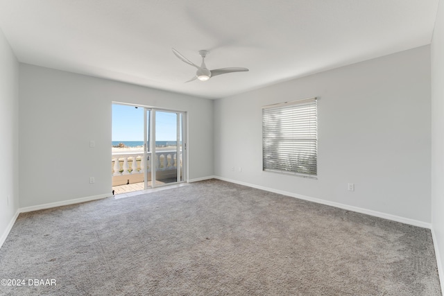 unfurnished room with ceiling fan, carpet floors, and a wealth of natural light