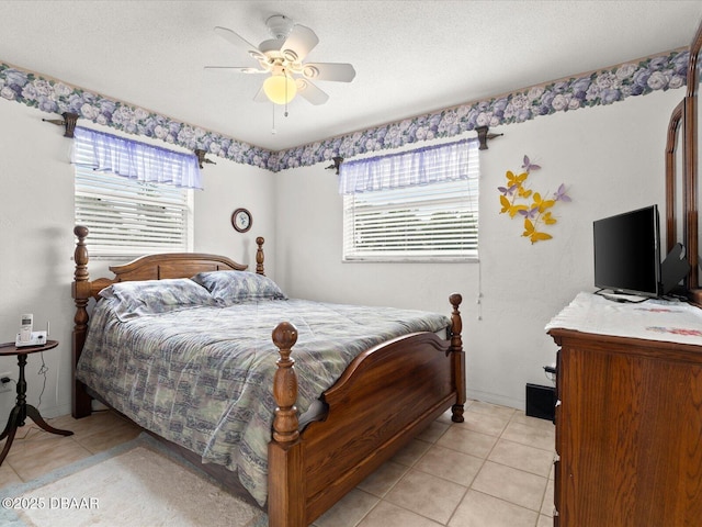 bedroom with a textured ceiling, ceiling fan, light tile patterned floors, and multiple windows