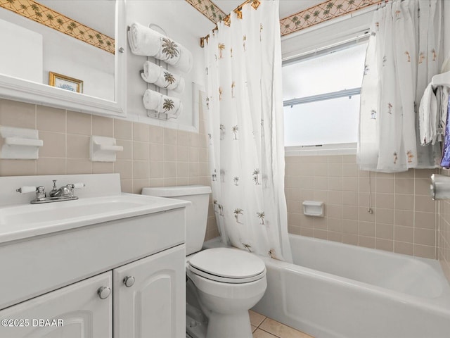 full bathroom with toilet, shower / bath combo, tile patterned flooring, tile walls, and vanity