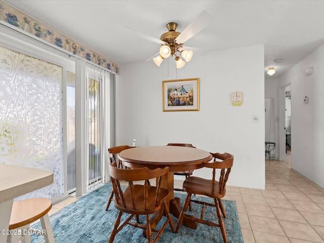 tiled dining area featuring ceiling fan