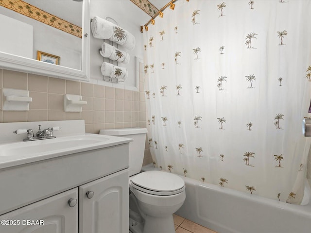 full bathroom featuring toilet, vanity, tile walls, tile patterned flooring, and shower / tub combo