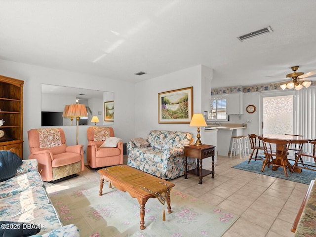 living room with ceiling fan and light tile patterned floors