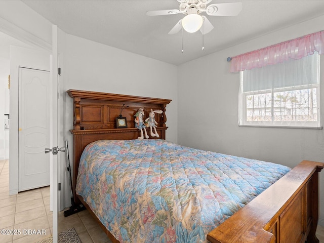 bedroom with ceiling fan and light tile patterned flooring