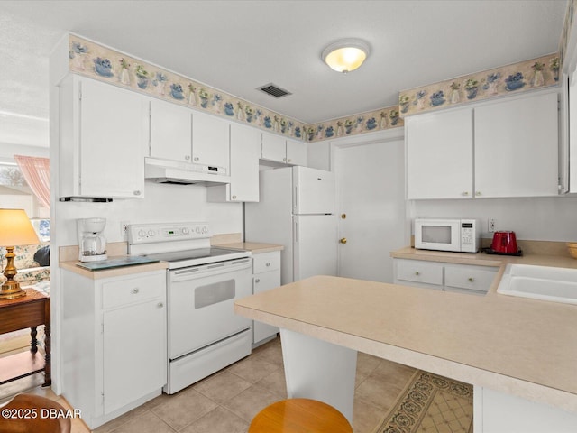 kitchen featuring light tile patterned floors, white cabinetry, sink, and white appliances