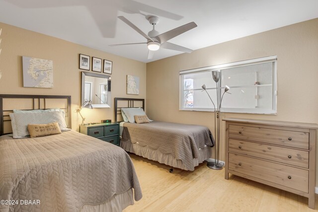 bedroom with ceiling fan and light wood-type flooring