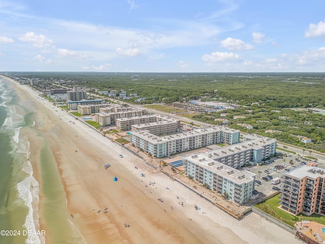 birds eye view of property featuring a beach view and a water view