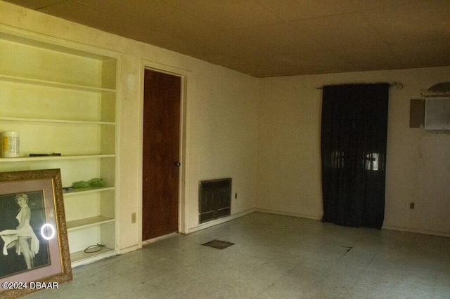 unfurnished room featuring built in features and heating unit