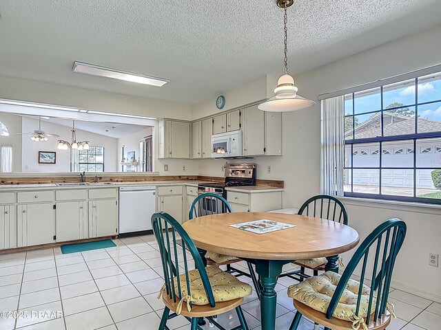 907 Silverleaf Pl, Port Orange, FL 32127 - dining room featuring a textured ceiling, light tile patterned floors, and plenty of natural light
