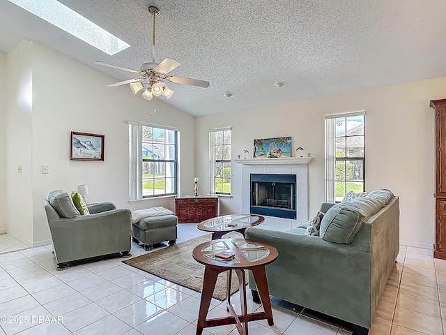 907 Silverleaf Pl, Port Orange, FL 32127 - living area with a textured ceiling, a tile fireplace, ceiling fan, and plenty of natural light