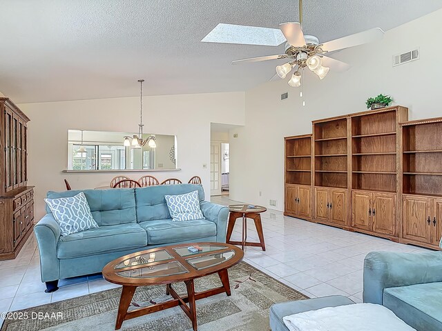 907 Silverleaf Pl, Port Orange, FL 32127 - living area with light tile patterned floors, visible vents, a textured ceiling, and ceiling fan with notable chandelier