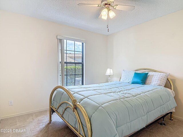 907 Silverleaf Pl, Port Orange, FL 32127 - bedroom with a textured ceiling, carpet, baseboards, and a ceiling fan