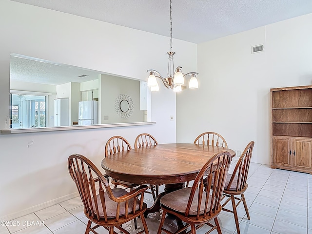 907 Silverleaf Pl, Port Orange, FL 32127 - dining room featuring an inviting chandelier, a textured ceiling, light tile patterned floors, and visible vents