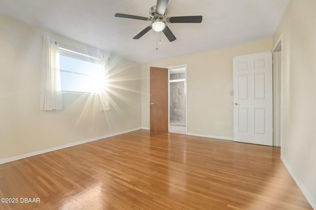 unfurnished bedroom with light wood-style floors, baseboards, ensuite bathroom, and ceiling fan