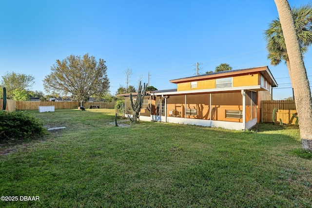 exterior space featuring a fenced backyard and a sunroom