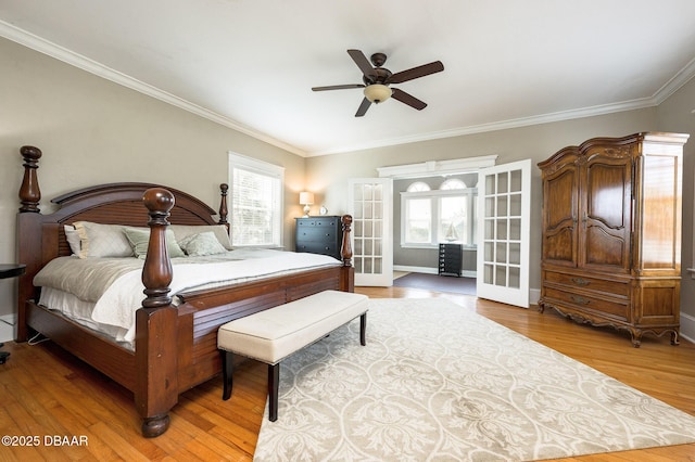 bedroom featuring french doors, wood-type flooring, ceiling fan, and ornamental molding