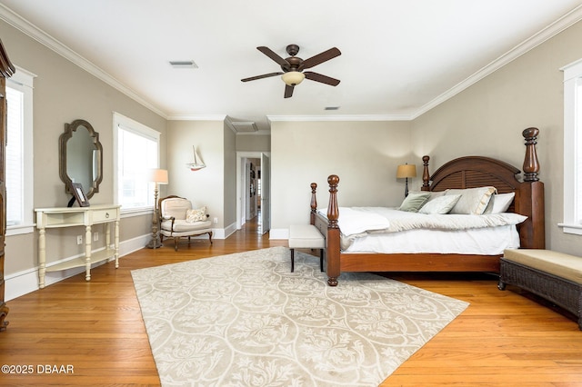 bedroom featuring ceiling fan, hardwood / wood-style floors, and crown molding