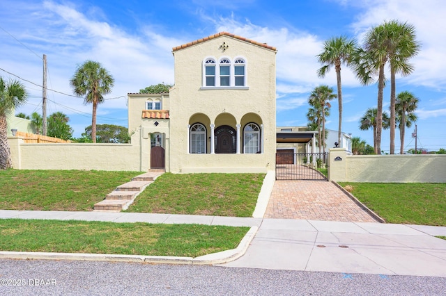 mediterranean / spanish home featuring a front yard