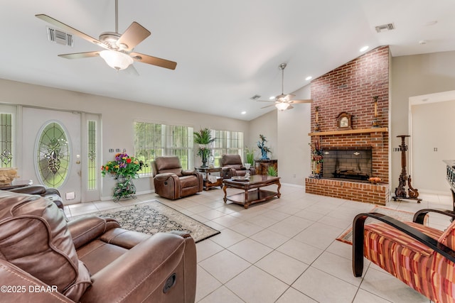 living area featuring visible vents, vaulted ceiling, a fireplace, and light tile patterned floors