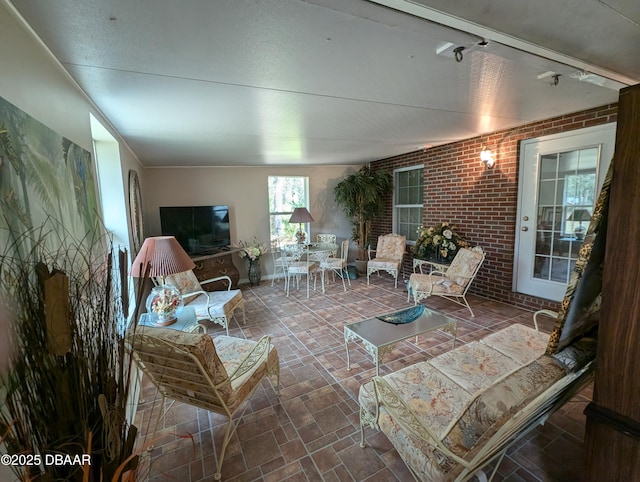 living room with brick wall