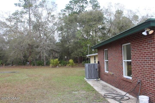 view of yard with central air condition unit