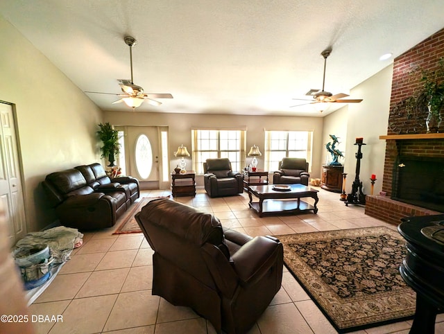 living room featuring lofted ceiling, a brick fireplace, and light tile patterned floors