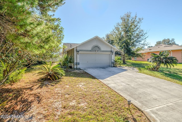 ranch-style home with a garage and a front lawn