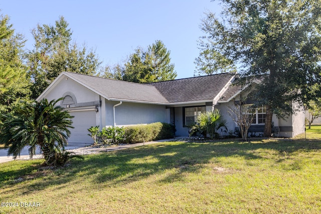 single story home with a garage and a front lawn