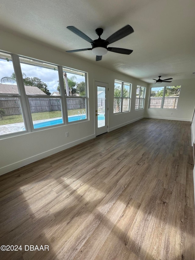 interior space with ceiling fan