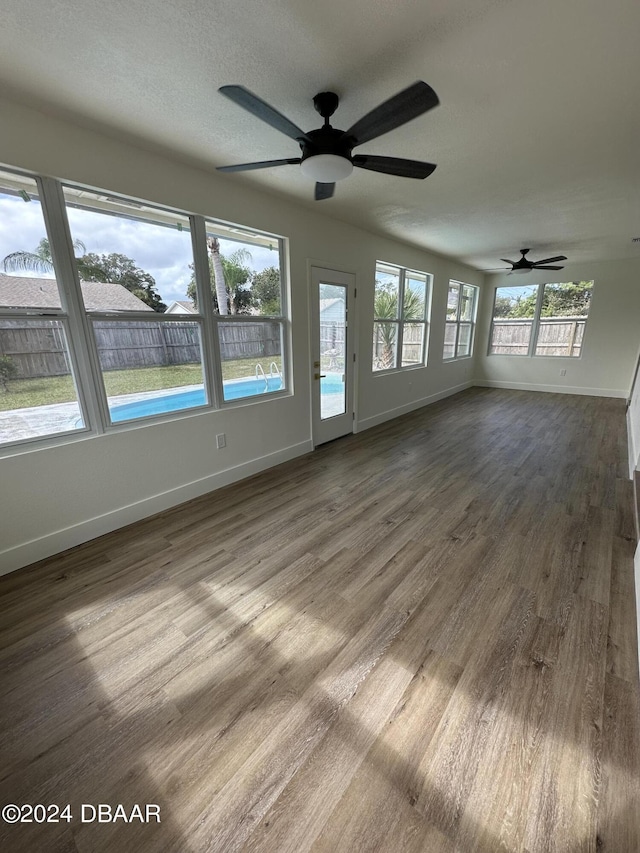 1824 Sabal Palm Dr, Edgewater, FL 32132 - unfurnished living room featuring baseboards, wood finished floors, and ceiling fan