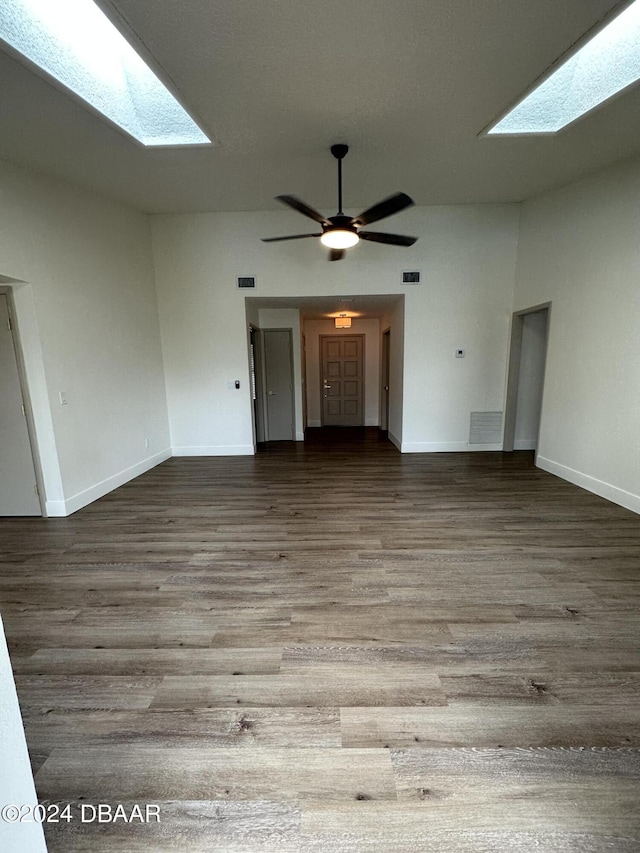 1824 Sabal Palm Dr, Edgewater, FL 32132 - unfurnished living room with a skylight, wood finished floors, and baseboards