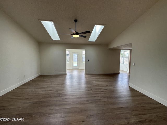 1824 Sabal Palm Dr, Edgewater, FL 32132 - unfurnished room with a skylight, healthy amount of natural light, dark wood-type flooring, high vaulted ceiling, and a textured ceiling