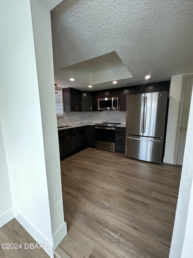1824 Sabal Palm Dr, Edgewater, FL 32132 - kitchen featuring stainless steel appliances, light countertops, wood finished floors, a textured ceiling, and recessed lighting