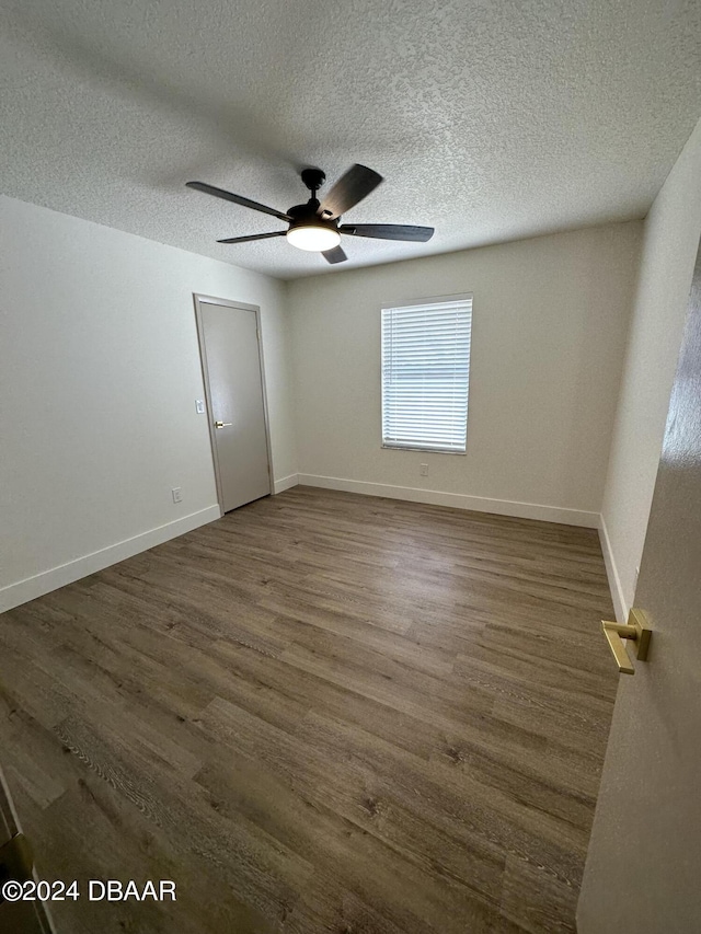 1824 Sabal Palm Dr, Edgewater, FL 32132 - unfurnished room featuring a ceiling fan, dark wood finished floors, a textured ceiling, and baseboards