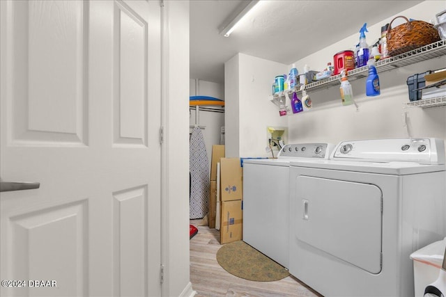 laundry room with light hardwood / wood-style floors and independent washer and dryer