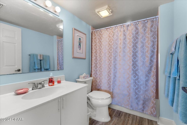 full bathroom featuring hardwood / wood-style floors, vanity, toilet, and shower / bathtub combination with curtain